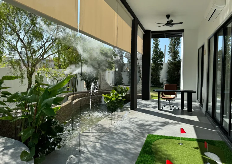 Private garden terrace at Bungalow Dees with a water feature, misting garden and putting green