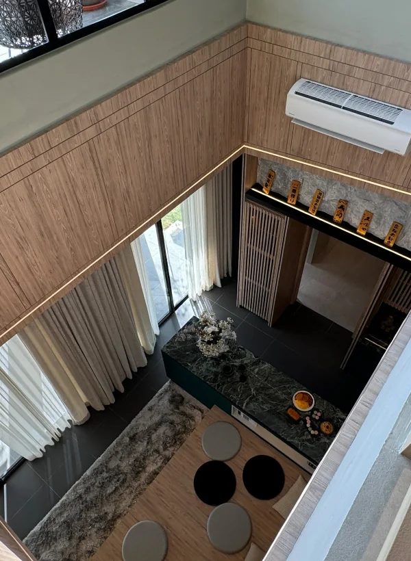 View down into the double-volume living hall from the upper landing at Bungalow Dees